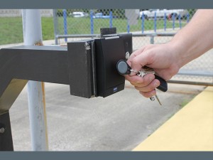image of hand unlocking gate with rf key fob